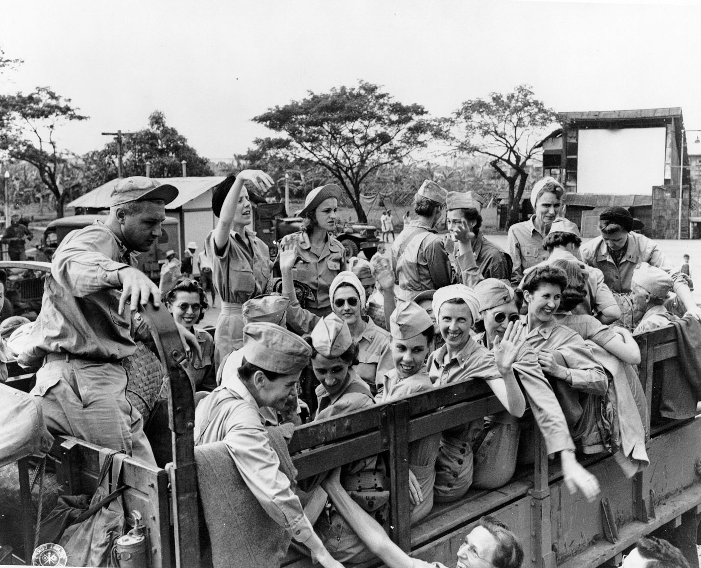 A joyous Bradley (center, waving) after being released from Japanese imprisonment, 1945. By US Army